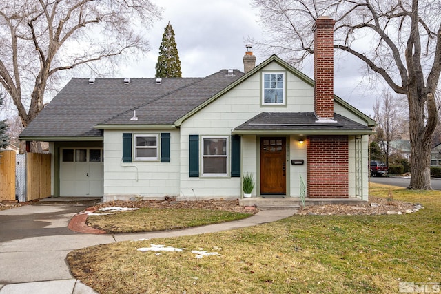 bungalow-style house featuring a garage and a front lawn