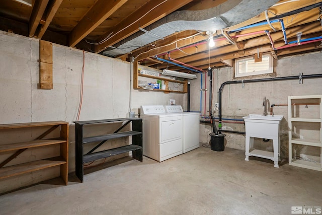 basement featuring sink and washing machine and dryer