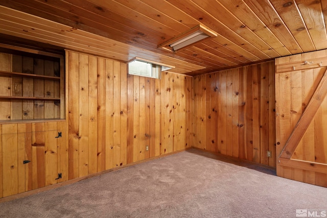 interior space with carpet floors, wooden ceiling, and wooden walls