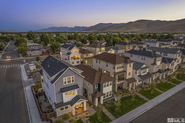 aerial view at dusk featuring a mountain view