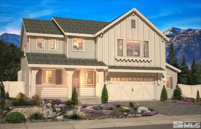 view of front facade with a shingled roof, a porch, board and batten siding, fence, and driveway