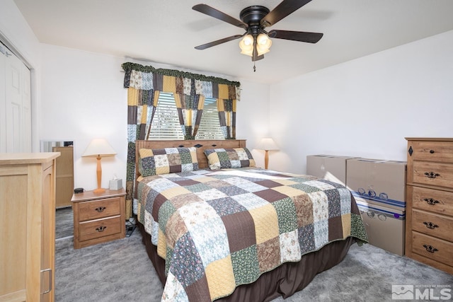 carpeted bedroom with a closet and ceiling fan