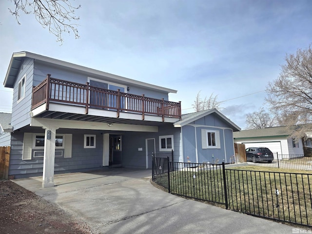 view of front facade featuring an outbuilding, a balcony, a garage, and a front lawn