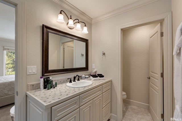 bathroom with ornamental molding, toilet, tile patterned flooring, and vanity