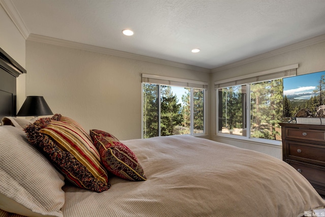 bedroom with crown molding and a textured ceiling