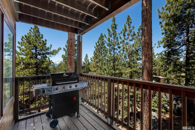 wooden terrace featuring a grill