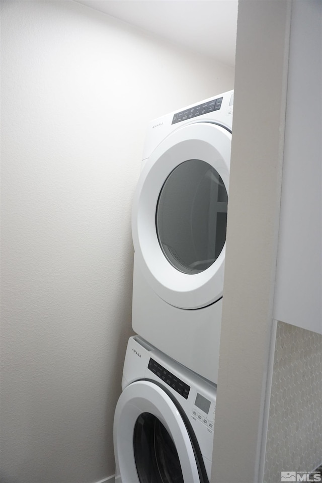 laundry room with stacked washer and clothes dryer