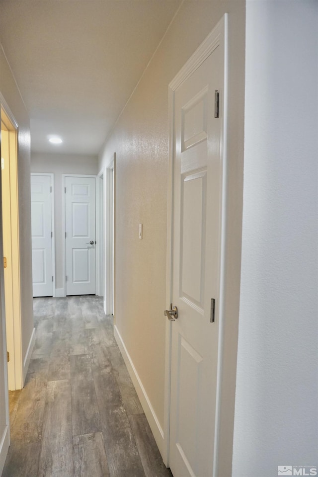 corridor with wood-type flooring