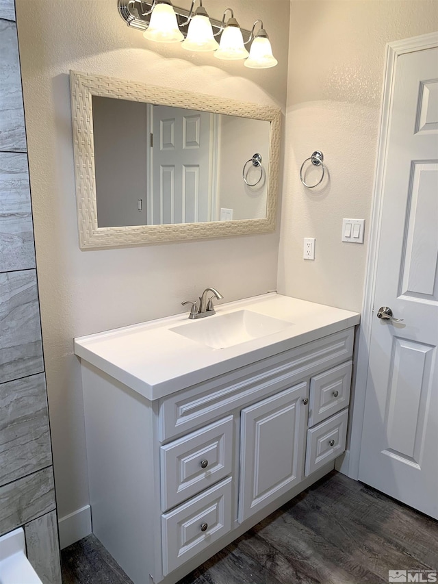 bathroom with vanity and hardwood / wood-style floors