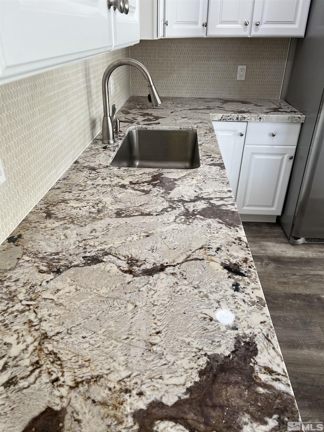 kitchen featuring white cabinets, sink, stainless steel fridge, and dark hardwood / wood-style flooring