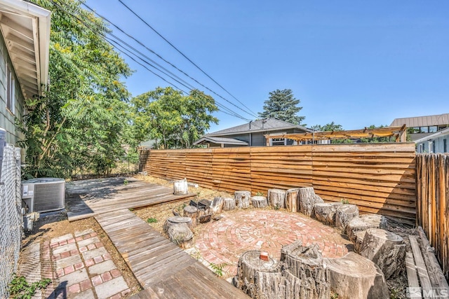 wooden terrace with a patio area and central air condition unit