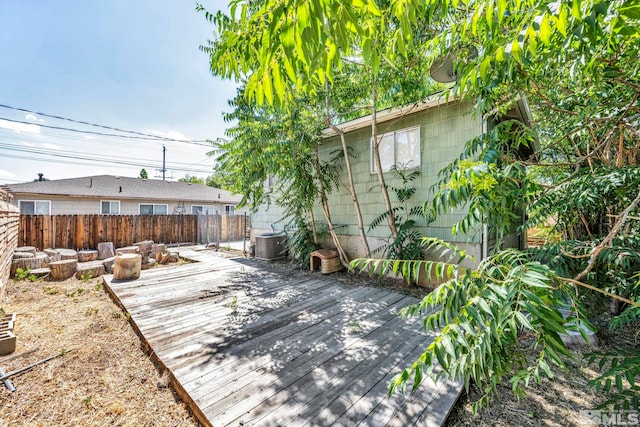 wooden deck featuring cooling unit