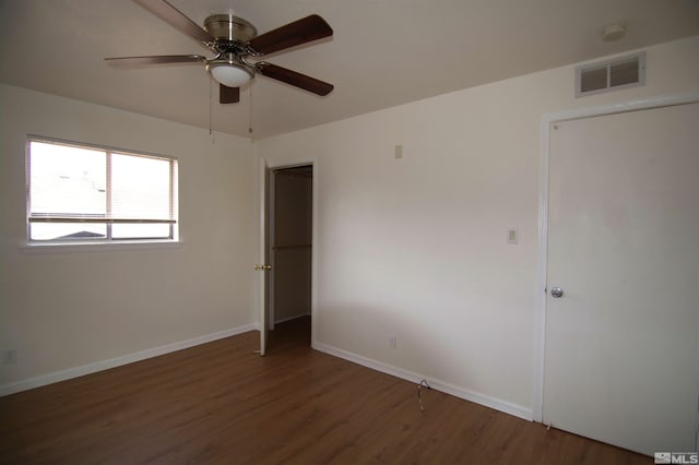 unfurnished bedroom featuring dark wood-type flooring and ceiling fan