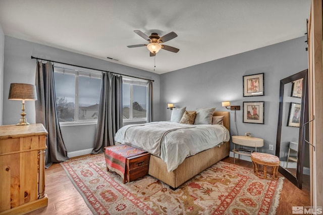 bedroom with ceiling fan and light hardwood / wood-style floors