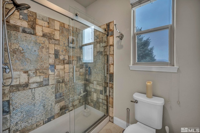 bathroom with toilet, plenty of natural light, and walk in shower