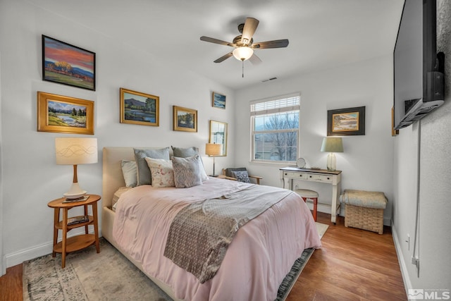 bedroom with ceiling fan and light hardwood / wood-style floors