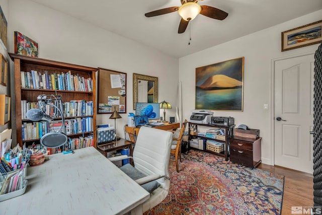 office area with hardwood / wood-style flooring and ceiling fan