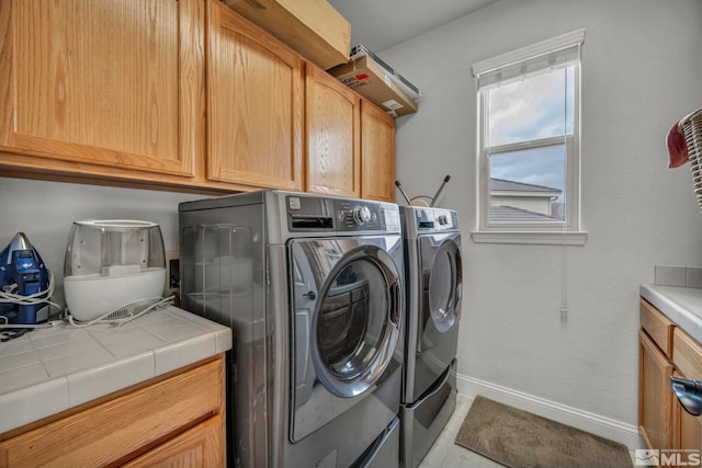 laundry area with cabinets and washer and dryer