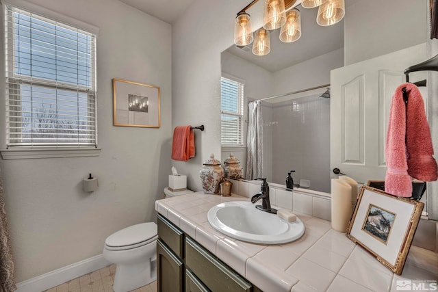 bathroom featuring a shower with curtain, vanity, and toilet