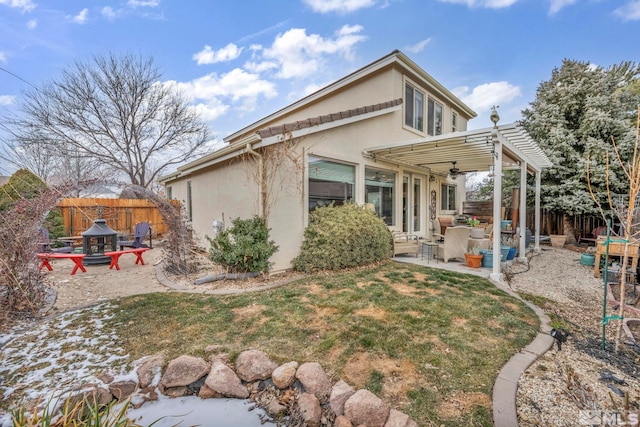 back of property featuring a patio area and a pergola