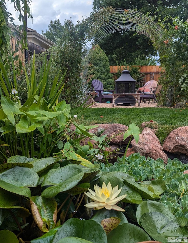 view of yard featuring a fire pit and a patio