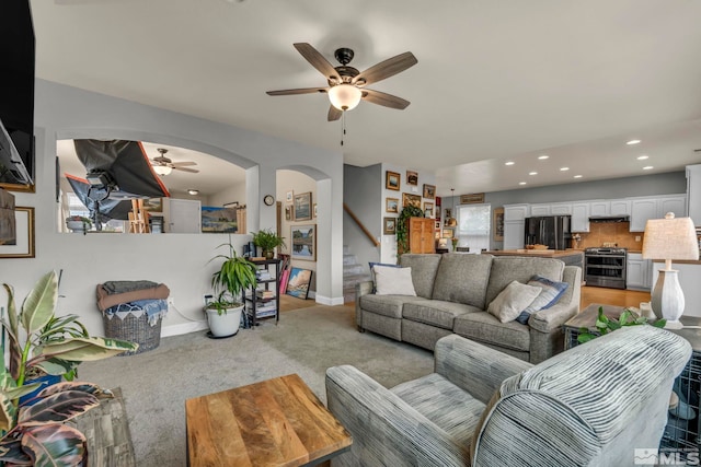 living room with light carpet and ceiling fan