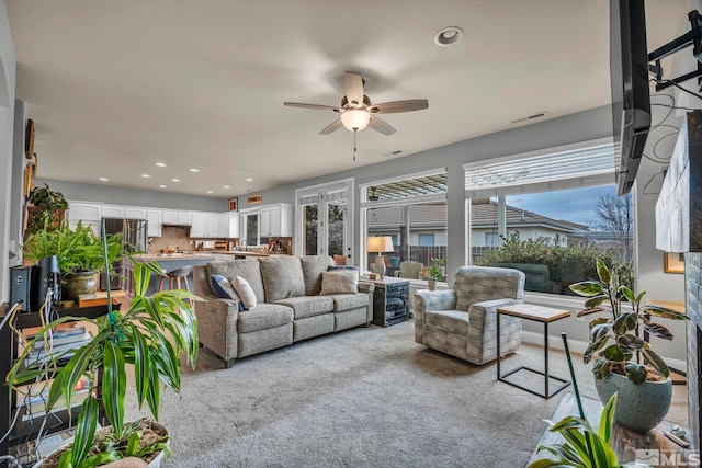 living room with light carpet and ceiling fan