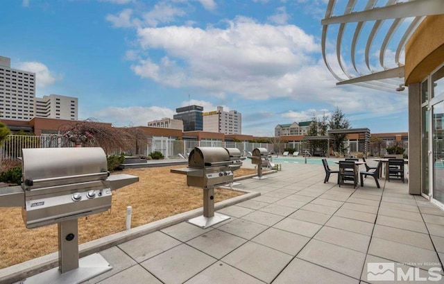 view of patio / terrace featuring area for grilling, a community pool, and a pergola