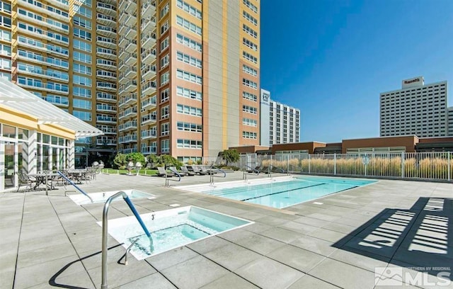 view of pool featuring a community hot tub and a patio