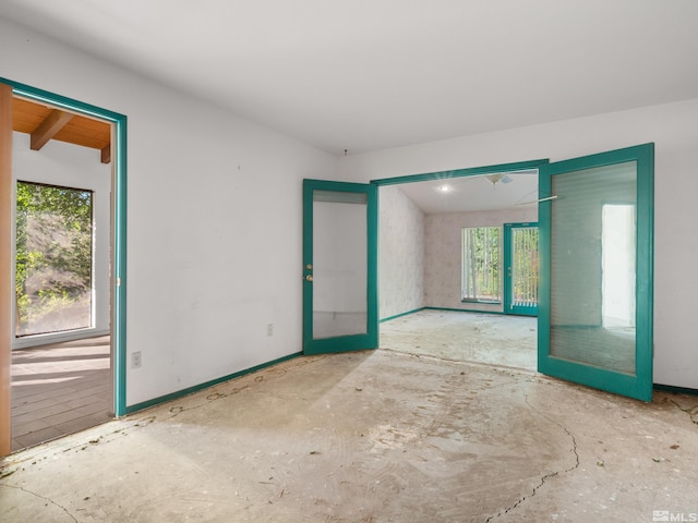 unfurnished room featuring french doors