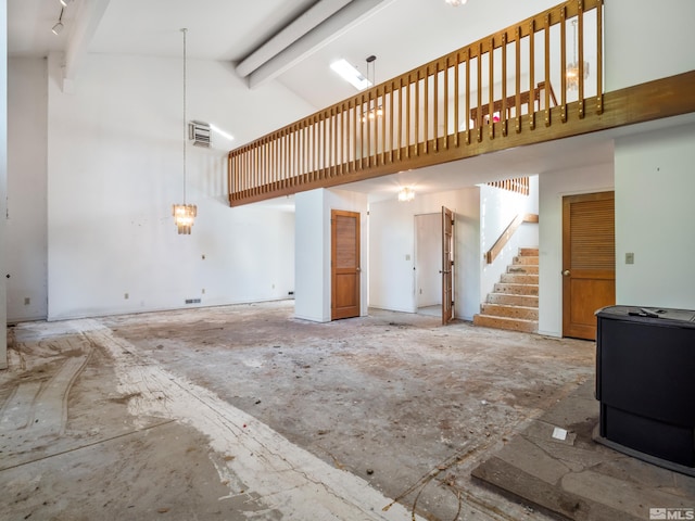 living room with beam ceiling and high vaulted ceiling