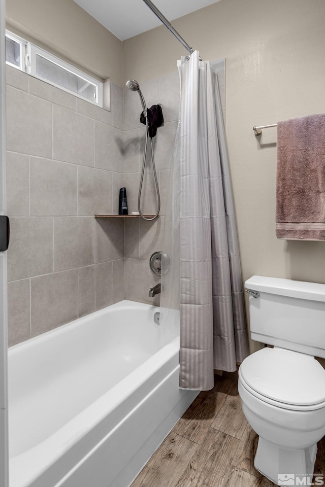 bathroom featuring shower / bath combo and toilet