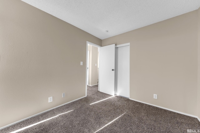 unfurnished bedroom featuring carpet floors and a textured ceiling