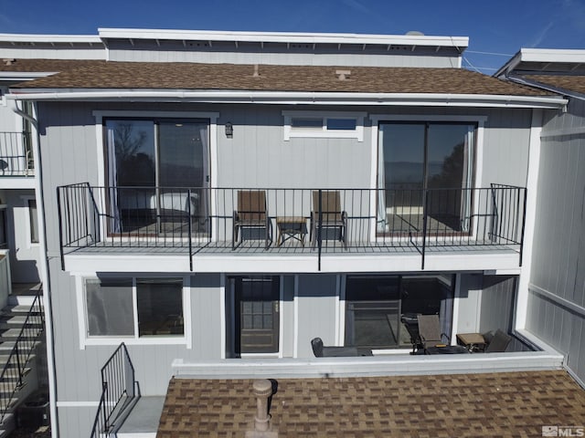 rear view of house featuring a balcony