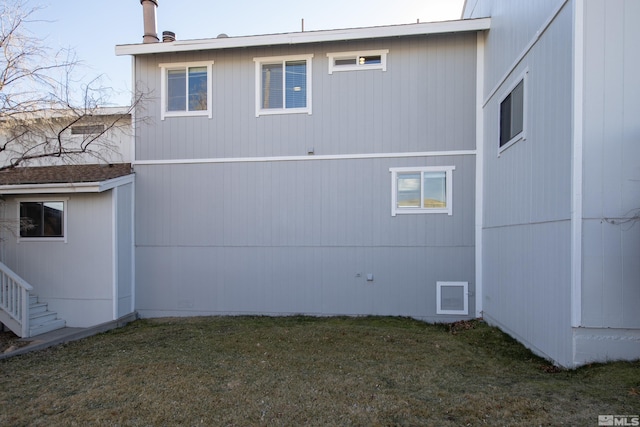 rear view of house featuring a yard