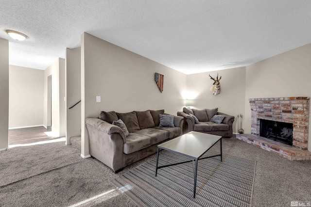 carpeted living room featuring a brick fireplace and a textured ceiling