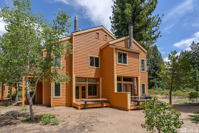 back of house with a wooden deck