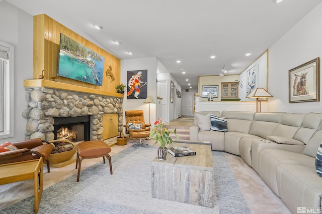 living room featuring a stone fireplace