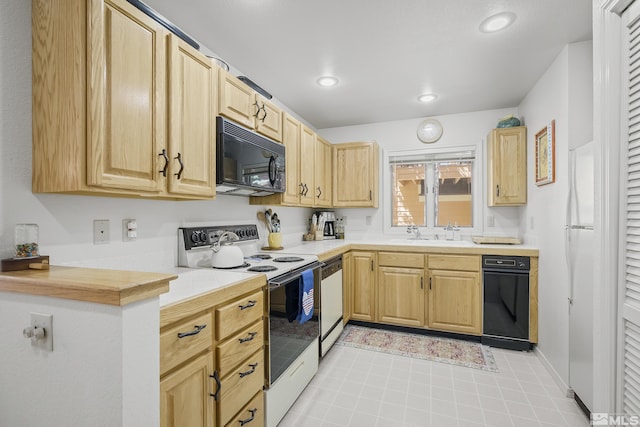 kitchen featuring stainless steel dishwasher, white electric range oven, sink, and light brown cabinets