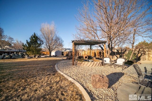 view of yard featuring a storage shed and a pergola