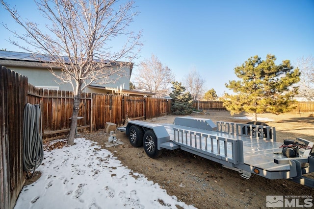 yard covered in snow featuring a deck