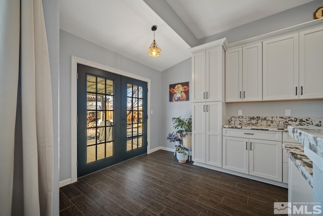 kitchen with white cabinetry, decorative light fixtures, and french doors