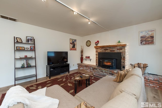 living room featuring hardwood / wood-style flooring and track lighting