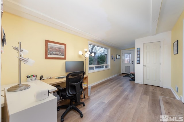 office area featuring lofted ceiling and light wood-type flooring