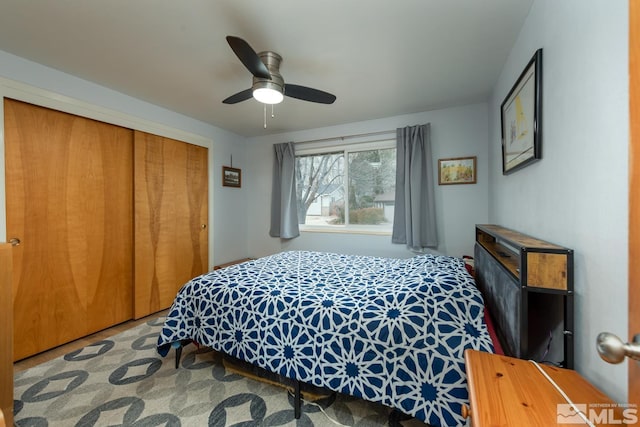 bedroom with ceiling fan and a closet