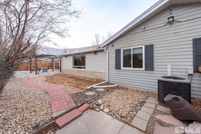 exterior space featuring central AC unit and a patio