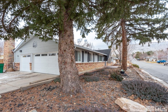 view of side of home featuring a garage