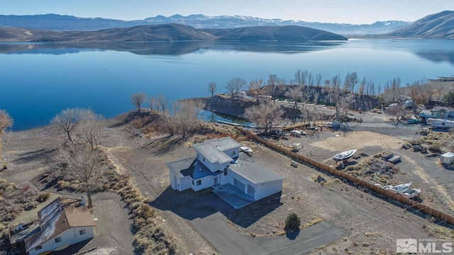 drone / aerial view with a water and mountain view