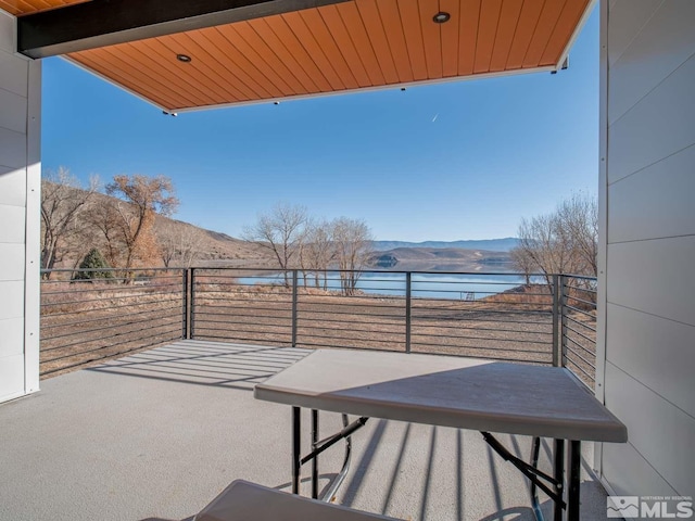 balcony with a water and mountain view