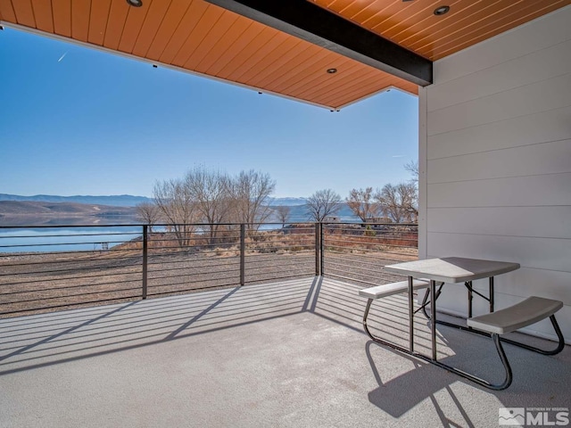 balcony featuring a water and mountain view